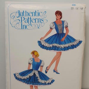 May include: A sewing pattern envelope from Authentic Patterns Inc. featuring illustrations of a blue dress with white puff sleeves, a square neckline, and a ruffled hem. The envelope displays the sizes 12, 14, and 16 in the upper right corner.