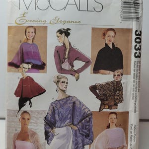 May include: A McCall's Evening Elegance sewing pattern envelope, number 3033, featuring illustrations of various capes, boleros, and wraps. The white paper envelope displays six different garment styles labeled A through F, with text.