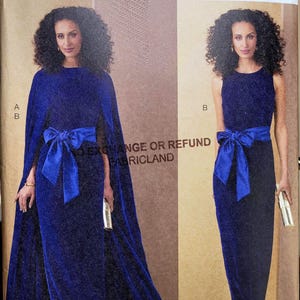 May include: Vogue Patterns V2132 sewing pattern envelope featuring two views of a floor-length royal blue dress with a waist tie. View A includes a cape overlay, while View B is sleeveless. The text V2132, SIZE/TAILLE B5 (8-10-12-14-16) is visible.