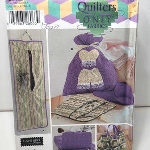 May include: A Simplicity 5822 sewing pattern envelope for Quilters Only Fabrics by Elaine Heigl Designs. The package displays illustrations of various fabric bags, including a hanging organizer, a drawstring pouch, and a tote bag.
