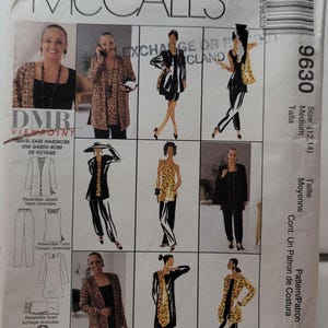 May include: A McCall's 9630 sewing pattern envelope for a travel ease wardrobe. The front displays illustrations and photographs of a reversible jacket, tunic, and scarf in black and leopard print fabrics, with size 12-14 indicated on the side.