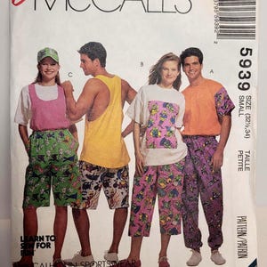 May include: An Easy McCall's sewing pattern envelope 5939 for sportswear in size small. The cover features illustrations of four outfits: a pink tank with green shorts, a yellow tank with patterned shorts, a white tee with pink pants, and an orange tee with purple pants.