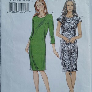 May include: A Very Easy Vogue sewing pattern envelope V8786 featuring two dress designs. One is a solid green knee-length dress with three-quarter sleeves, and the other is a black and white patterned dress with short sleeves. Includes size E5.
