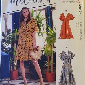 May include: McCall's sewing pattern M8104 featuring a woman in a yellow dress with black spots. The pattern includes multiple dress styles, with sizes A5/F5 (6-24). The pattern is produced in partnership with Love Sewing.