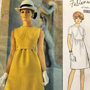 May include: A Vogue Couturier Design sewing pattern envelope for Fabiani of Italy, number 2065. The front features a yellow sleeveless dress with a high neckline and a white hat, alongside a line drawing of a white short-sleeved dress.