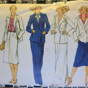 May include: Vogue Patterns sewing pattern envelope showing illustrations of women in business suits. The suits are in blue and white, with different jacket, skirt, and trouser styles. The envelope includes the Vogue Patterns logo and size details.