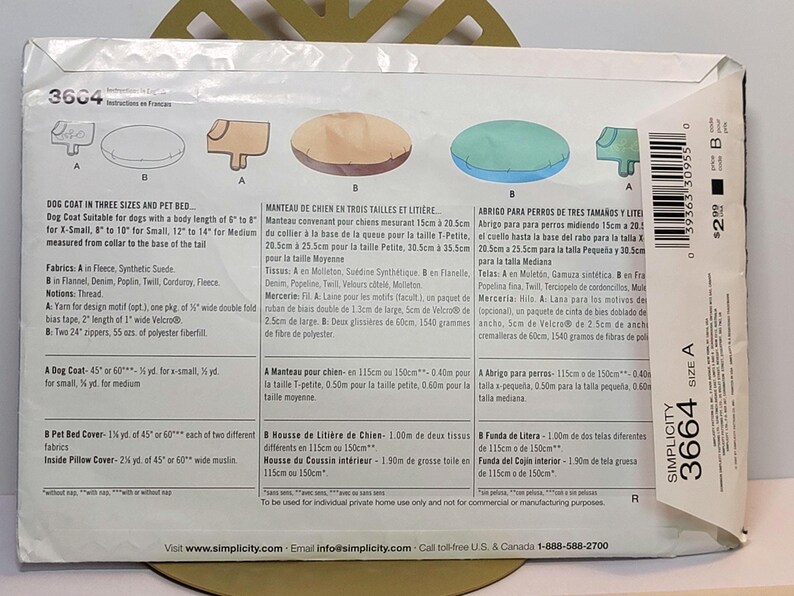 May include: A Simplicity 3664 sewing pattern envelope for a dog coat and pet bed. The back of the white paper envelope displays illustrations of the finished items in tan and blue, along with detailed instructions, fabric requirements, and a barcode.