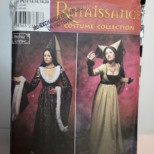 以下が含まれることがあります： Simplicity 9058 Renaissance Costume Collectionの縫製パターン封筒。2種類のドレスデザインが掲載されています。デザインAは白いファーのトリミングが施された黒いドレスと高いヘッドドレス。デザインBは黒いボディスのゴールドのドレスと角のあるヘッドドレスです。