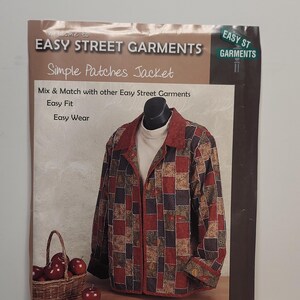 May include: A sewing pattern envelope for an Easy Street Garments Simple Patches Jacket. The cover features a jacket with a red, black, and tan patchwork design, a collar, and long sleeves. Text includes Easy Street Garments and FC 2400.