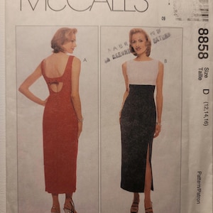 May include: McCall's sewing pattern 8858, size D (12, 14, 16). The envelope features illustrations of two floor-length dresses: a solid red sleeveless dress with a back cutout and a two-tone dress with a white bodice and a black skirt with a side slit.