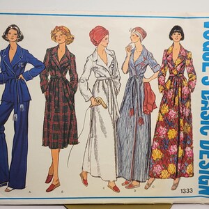 May include: A Vogue's Basic Design sewing pattern envelope 1333 featuring illustrations of five different robe and pajama styles. The designs include a solid blue pajama set, a plaid robe, a white robe, a striped robe, and a floral print robe.