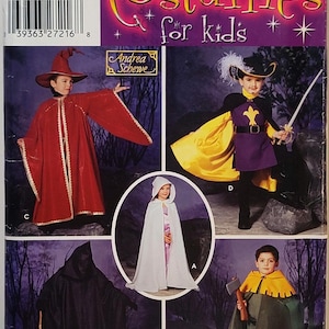 May include: A Simplicity sewing pattern envelope for children's costumes, labelled 0629, featuring illustrations of five different outfits: a red wizard robe, a purple and yellow musketeer costume, a white hooded cape, a black cloak, and a green tunic.