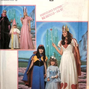 May include: A Simplicity sewing pattern envelope 9897, size A (XXS-LG), featuring illustrations of various fantasy-themed costumes including long dresses, capes, and crowns. The package displays multiple figures in colorful outfits against a backdrop.