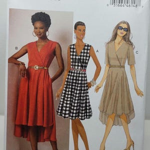 May include: Butterick sewing pattern B6204 for a wrap-style dress with a V-neckline, belted waist, and high-low hemline. The pattern envelope displays three variations: a solid red dress, a black and white gingham dress, and a solid tan dress.