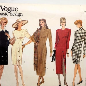 May include: A Vogue basic design sewing pattern envelope, number 1010, featuring illustrations of five different dress styles in sizes 12, 14, and 16. The designs include a black dress with white collar, a cream dress, a tan dress, a red dress, and a plaid dress.
