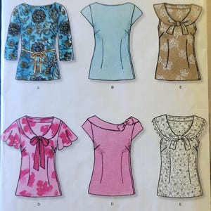 May include: A New Look sewing pattern showing six blouse designs. The blouses have diverse styles, including floral prints, bows, and varying sleeve lengths. The pattern includes the text "NEWLOOK" and "easy".