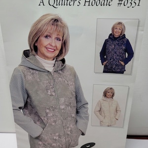 May include: A sewing pattern titled A Quilter's Hoodie #0351 by Zeffect Pattern Company. The cover features a hooded zip-up jacket with a textured floral front panel and solid sleeves. Two smaller inset photos show the jacket in dark blue and cream.