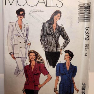 May include: A McCall's 5379 sewing pattern envelope for size 14 jackets. The front displays illustrations of four double-breasted blazer styles: a long white jacket, a houndstooth print jacket, a short-sleeved maroon jacket, and a short-sleeved blue jacket.