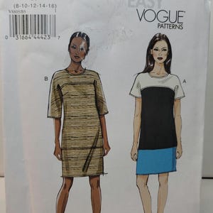 Könnte beinhalten: Ein Very Easy Vogue Patterns Schnittmusterumschlag V8805, Größe B5 (8-10-12-14-16). Die Vorderseite zeigt zwei Kleiderillustrationen: eines aus strukturiertem beigem Stoff und eines mit einem weiß-schwarz-blauen Color-Blocking-Design.