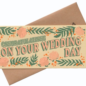 May include: A light yellow card with a floral border and the text "Congratulations on your wedding day" in green and pink letters.