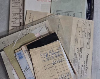 May include: A collection of vintage paper ephemera including a United States Savings Bond envelope, a Pennsylvania Power and Light Company bill, and a handwritten 1958 tax receipt. The documents feature various printed forms, grids, and text.