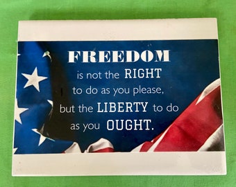 A 6”x8” porcelain tile with a patriotic saying on it