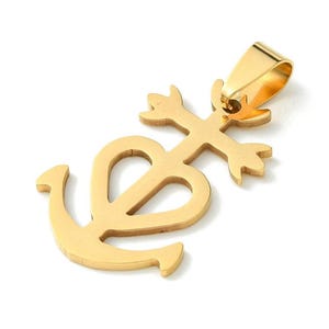 May include: Gold-colored pendant featuring an anchor design with a cross element. The pendant has a bail for attaching to a chain. The anchor is stylized with a heart shape in the center. The pendant is likely made of metal.