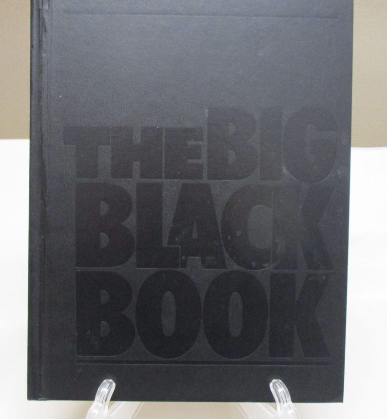 May include: A black book with the title "THE BIG BLACK BOOK" embossed on the cover. The book is rectangular and appears to be hardcover. The text is in a bold, sans-serif font.