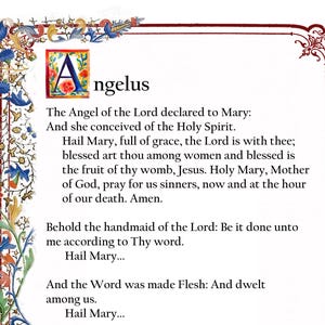 May include: A printed document featuring the Angelus prayer in black text on a white background. The letter A is an illuminated capital with floral motifs. A decorative border with blue, red, and yellow floral patterns frames the left and top edges.