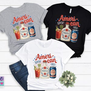 May include: Three t-shirts, gray, black, and white, each featuring a graphic with the text "American Sippin' Chill." The design includes a tequila bottle, a cocktail, and a can with "USA" on it. The shirts are short-sleeved.