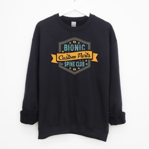 May include: Black sweatshirt with a vintage-style logo that says "Bionic Custom Parts - Spine Club".