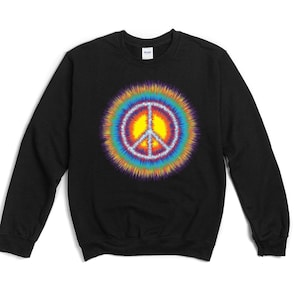 May include: Black crewneck sweatshirt featuring a vibrant, tie-dye peace sign graphic. The peace symbol is centered on the chest, with a yellow center and a radiating rainbow of colors. The sweatshirt is made of a soft material.