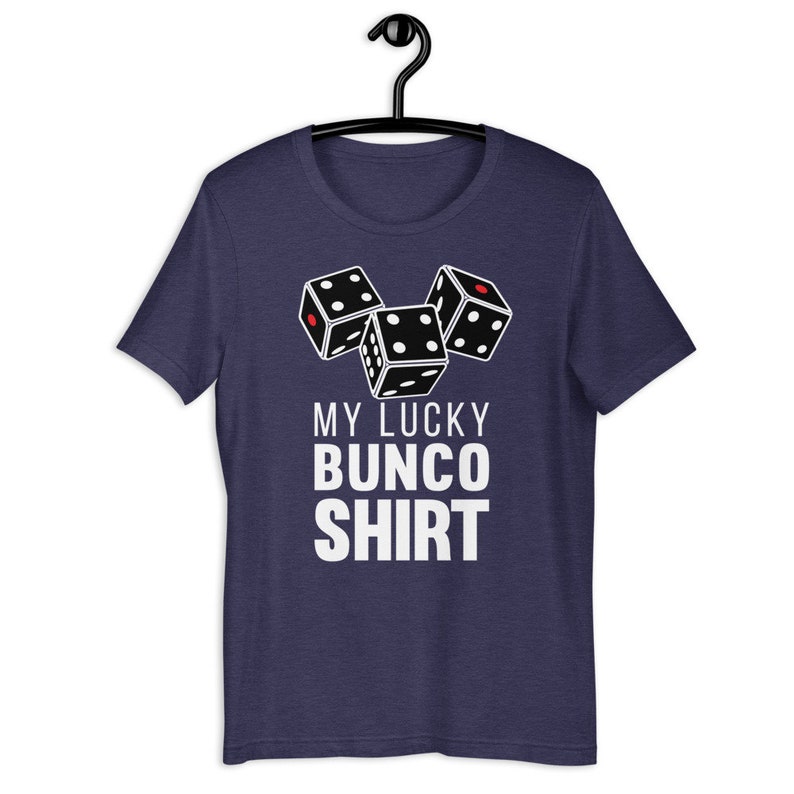 May include: A navy blue t-shirt with a white graphic of three dice and the text "My Lucky Bunco Shirt".