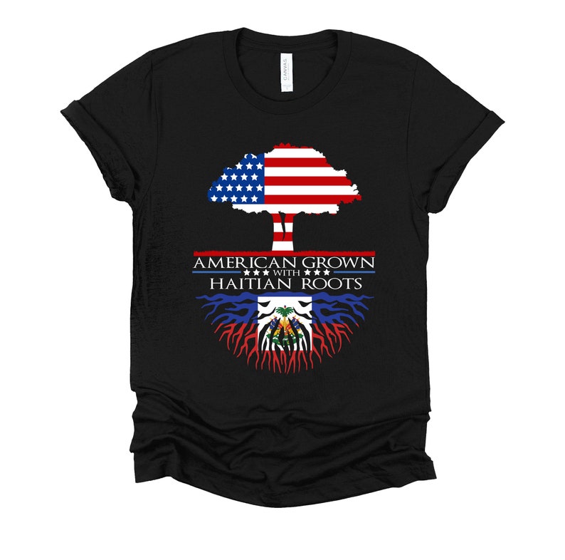 May include: Black t-shirt with a tree design. The tree trunk is the Haitian flag and the treetop is the American flag. The text reads "American Grown with Haitian Roots".