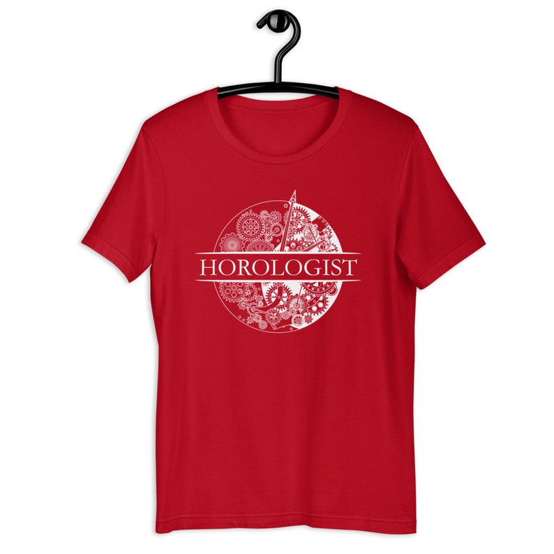 May include: Red t-shirt with a white design of a clock face with gears and the word "HOROLOGIST" printed below.