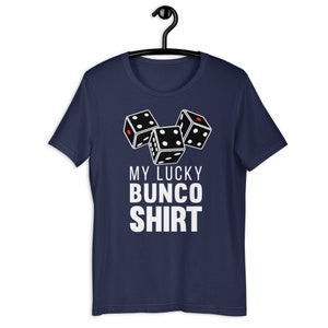 May include: A navy blue t-shirt with a white graphic of three dice and the text "My Lucky Bunco Shirt".