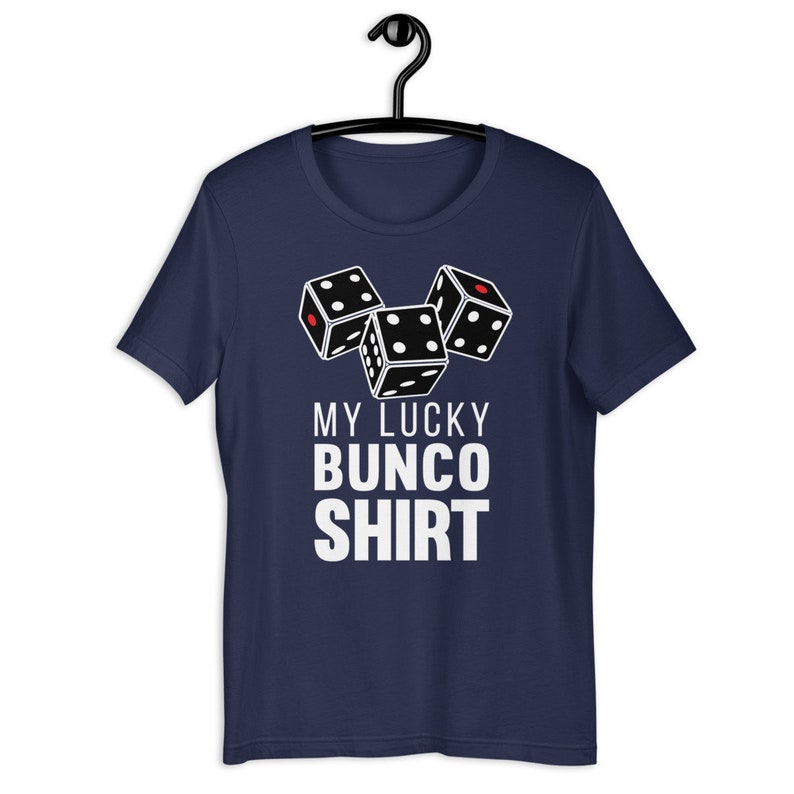 May include: A navy blue t-shirt with a white graphic of three dice and the text "My Lucky Bunco Shirt".