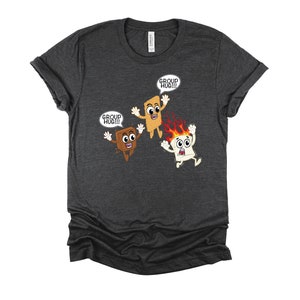 May include: A dark heather grey t-shirt with a graphic of three cartoon s'mores. The s'mores are smiling and have arms and legs. The text "Group Hug!!!" is in a speech bubble above each s'more.