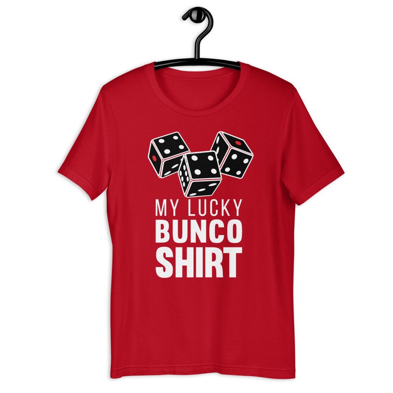 May include: Red short-sleeved t-shirt with a white graphic of three dice and the text "My Lucky Bunco Shirt".