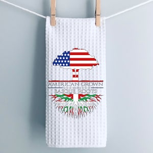 May include: White kitchen towel with a design of an American flag tree with Basque roots. The text reads "American Grown with Basque Roots".