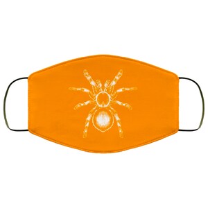 K&ouml;nnte beinhalten: Orangefarbene Gesichtsmaske mit einem wei&szlig;en Tarantula-Spinnen-Design. Die Maske hat schwarze Ohrschlaufen und besteht aus einem weichen, atmungsaktiven Stoff. Die Spinnengrafik ist detailliert und mittig auf der Maske platziert.