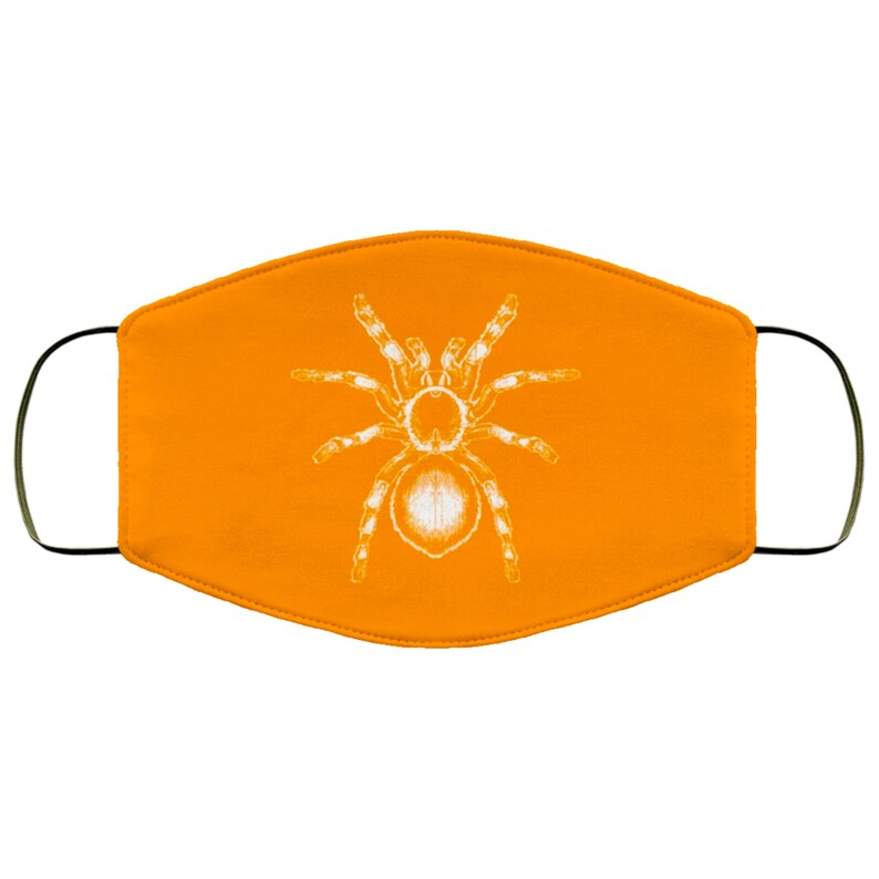 K&ouml;nnte beinhalten: Orangefarbene Gesichtsmaske mit einem wei&szlig;en Tarantula-Spinnen-Design. Die Maske hat schwarze Ohrschlaufen und besteht aus einem weichen, atmungsaktiven Stoff. Die Spinnengrafik ist detailliert und mittig auf der Maske platziert.