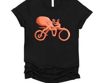 May include: Black t-shirt with a graphic of an orange octopus riding a bicycle.