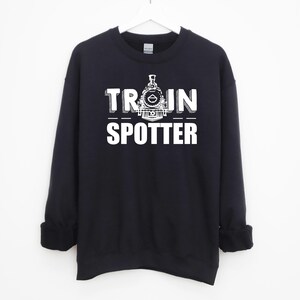 May include: Black sweatshirt with a white graphic of a train and the text "TRAIN SPOTTER".