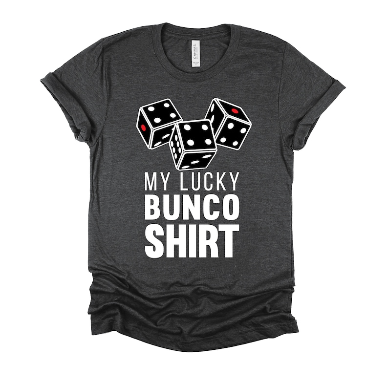 May include: A dark gray t-shirt with a white graphic of three dice and the text "My Lucky Bunco Shirt".