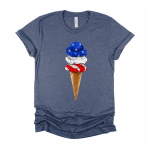 May include: A blue, white, and red ice cream cone with a waffle cone. The ice cream is shaped like the American flag.