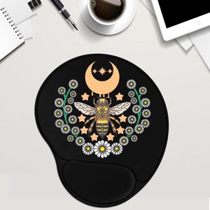 May include: Black mouse pad with a yellow and brown bee, a crescent moon, and white daisies. The bee has a honeycomb design and is surrounded by stars.