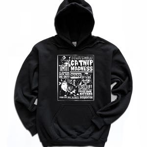 May include: Black hooded sweatshirt with a white graphic print of a vintage poster advertising "Catnip Madness". The poster features a cat with the text "It started with just one sniff! Chaos! Vice! Insanity! The scourge that drags our kittens to degradation."