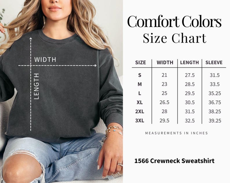 Op de afbeelding: Een donkergrijs Comfort Colors crewneck sweatshirt. De afbeelding bevat een maattabel met afmetingen in inches voor maten S t/m 3XL. De tekst "1566 Crewneck Sweatshirt" is ook zichtbaar.