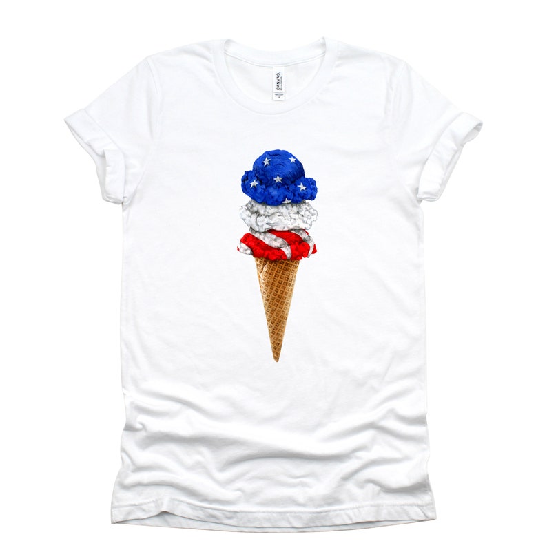 May include: White t-shirt with a graphic of an ice cream cone with red, white, and blue ice cream, resembling the American flag.